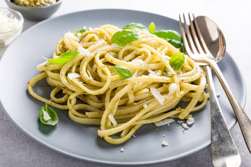 Homemade pasta, spaghetti, linguine with green pesto and basil. Italian healthy food concept. - obrazy, fototapety, plakaty