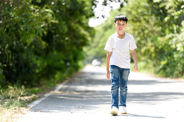 Fototapeta premium Boy walk on the road