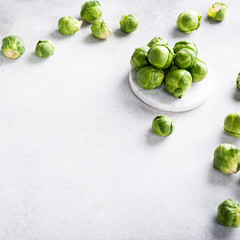 Background with Brussels sprouts on light gray stone table. Healthy food concept with copy space.