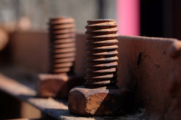 close up two rust old screw in front focus