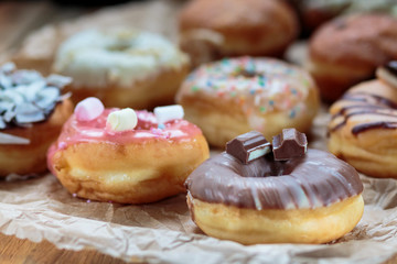 Delicious colorful donuts on baking paper