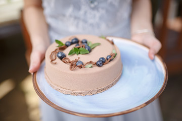 hands holding delicious creamy cake