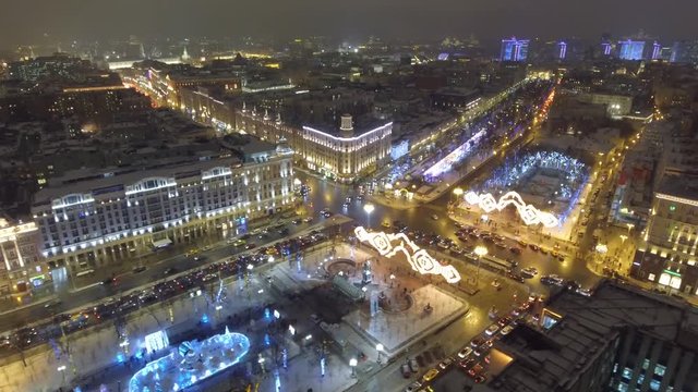 Pushkinskaya square holiday decoration. Night lights illumination. Aerial drone flight. Moscow Russia cowered in snow and ice.  New year city road traffic. High altitude camera drift. Panorama.