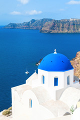 Fototapeta na wymiar Church with blue domes in Santorini island, Greece. Summer landscape, sea view