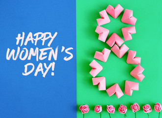 Happy International Women’s Day celebrate on March 8 CARD. rose-color paper hearts shape figure eight 8 on a green background