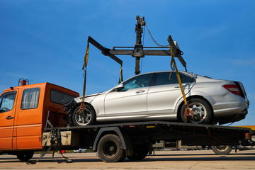 Tow truck loads smashed car after traffic accident