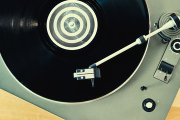 Gramophone with vinyl records  on a wooden table. Basic background for design
