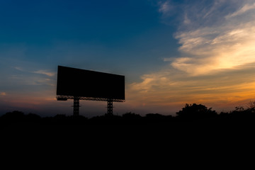 Silhouette Blank billboard with sky at sunset ready for new advertisement.