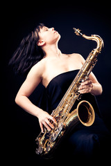 Obraz na płótnie Canvas Young Woman Playing The Sax