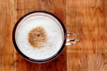 Coffee and milk in the mug, top view