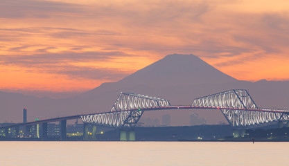 Tokyo bay at sunset with Tokyo gate bridge and Mountain Fuji .