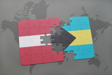 puzzle with the national flag of latvia and bahamas on a world map