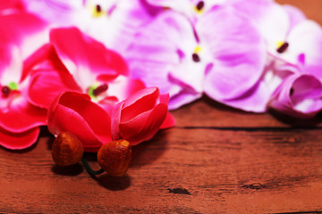 Beautiful orchid and lipstick on wooden background