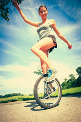 Young Woman Riding Her Unicycle © nullplus