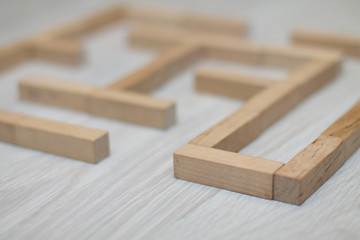 The maze is made up of wooden blocks on the board game