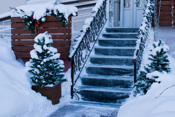 A large stone staircase with Christmas trees and Christmas decorations in winter
