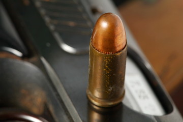 The pistol and bullet scene represent the weapon abstract concept related idea.