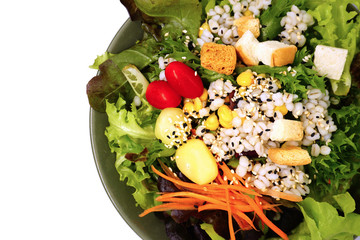 Fresh healthy green salad with saseme seeds on white background.