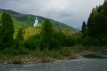 Fototapeta na wymiar Mountain river, a church in the mountains, ecology. 