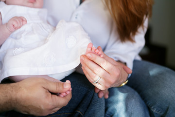 Young happy family holding a newborn baby