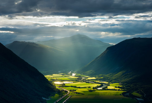 Sunlight breaking through the clouds over the valley Gudbrandsdalen, Norway