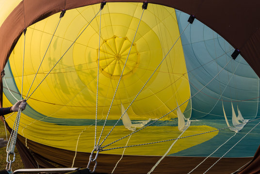 Inside an inflating hot air balloon, abstract colored background into the envelope of the balloon