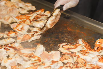 Hands of man take cooking of chicken meat
