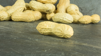 Dry peanuts on a background of slate