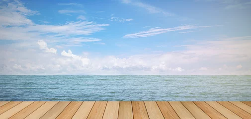 pier wood floor beside sea with blue sky background. summer relaxing time.
