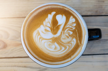 latte art coffee on wooden table