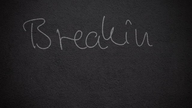 Handwritten saying "Breaking the rules" on a wall