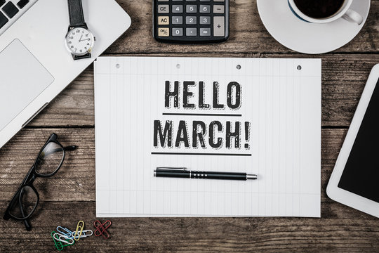 Hello March statement on notepad on office desk from above