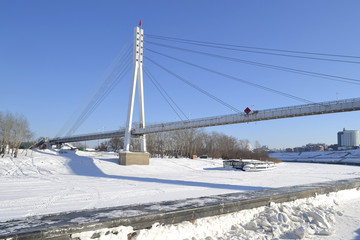 View of the bridge fallen in love in Tyumen in the winter, Russia. February 17, 2017.