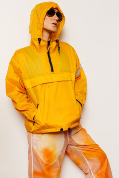Model in stylish orange sportswear and accessories. Bright season. Snowboard fashion style