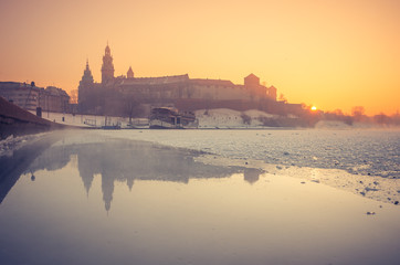 Fototapeta na wymiar Krakow, Poland, Wawel Castle and Wawel cathedral in the winter over frozen Vistula river in the morning