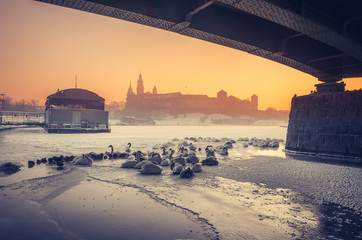 Krakow, Poland, Wawel Castle and Wawel cathedral  in the winter over frozen Vistula river in the morning