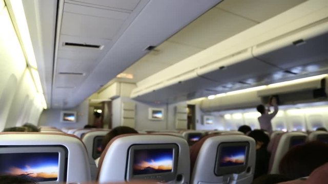 passengers sitting inside airplane during flight-Dan