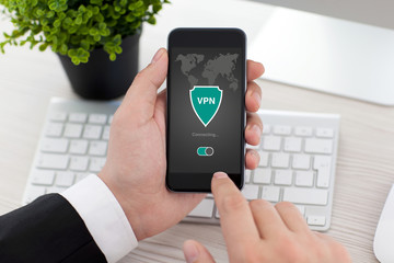man holding phone app vpn creation Internet protocols protection network