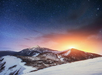 Fototapeta na wymiar fantastic winter meteor shower and the snow-capped mountains