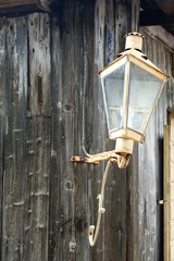 detail of a lamp on a wooden cottage