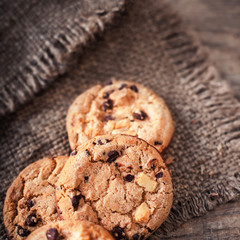 Chocolate chip cookies on dark old wooden table with place for text.,  freshly baked. Selective Focus with Copy space.