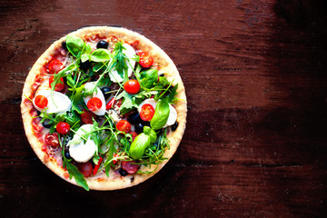 Fresh baked pepperoni pizza close up on wooden table, shallow depth of field, 