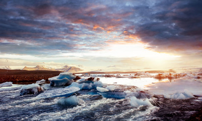 Jokulsarlon glacier lagoon, fantastic sunset on the black beach,