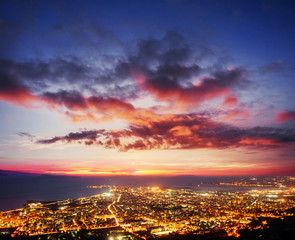 Fantastic pink sunset and cumulus clouds over the city. Beautifu
