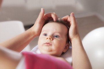Baby boy receiving treatment from osteopath, Munich, Bavaria, Germany