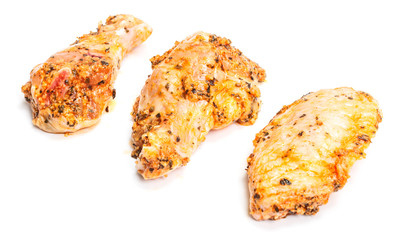 Marinated chicken wing parts on white background