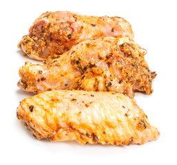 Marinated chicken wing parts on white background