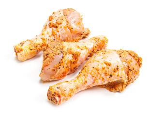 Marinated chicken drumsticks on white background