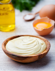 Homemade mayonnaise, mayo in a wooden bowl. White background