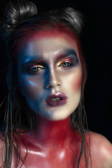 Beauty close-up portrait of beautiful woman model face with magic creative fashion multicolored make-up. Face painting, cosmetics, beauty and makeup.